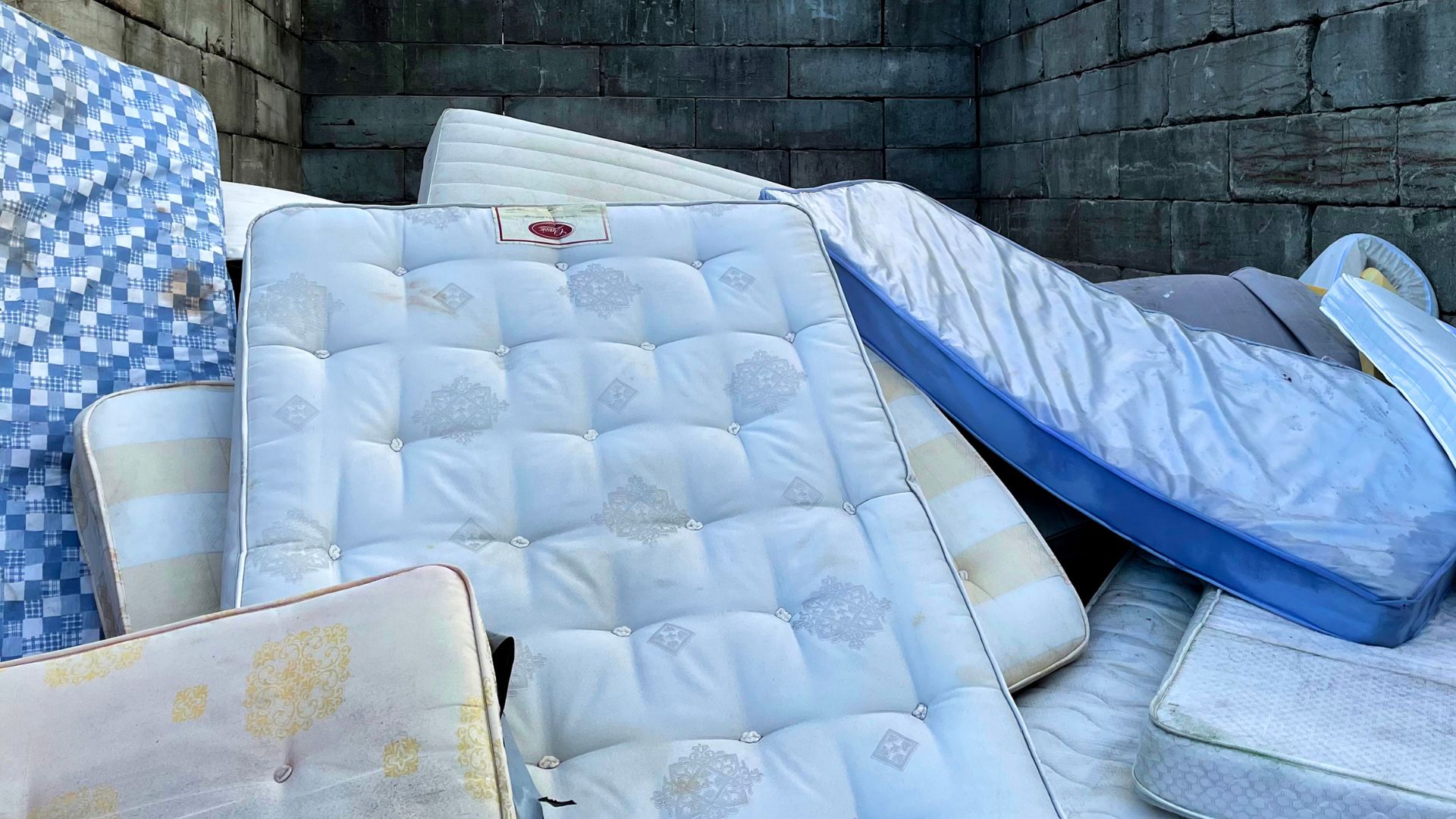 A pile of mattresses sitting next to each other