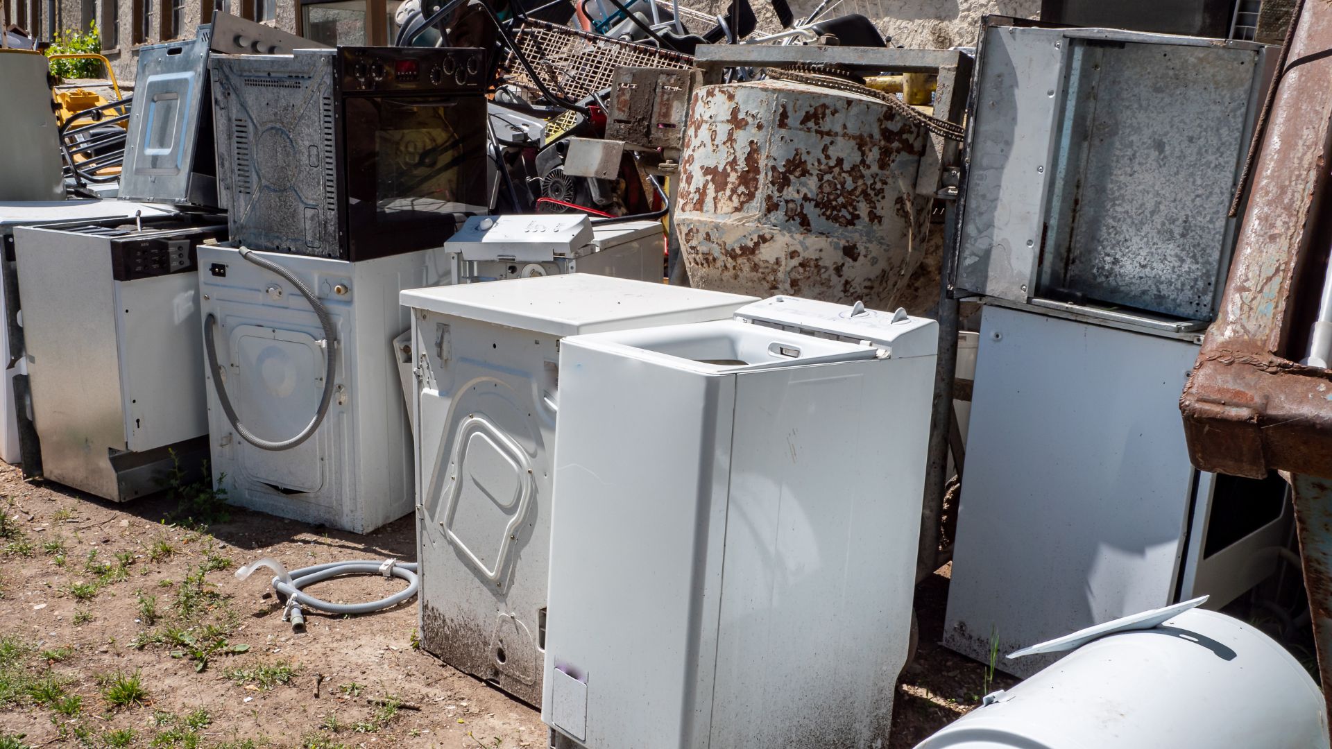 A pile of old appliances sitting in a yard