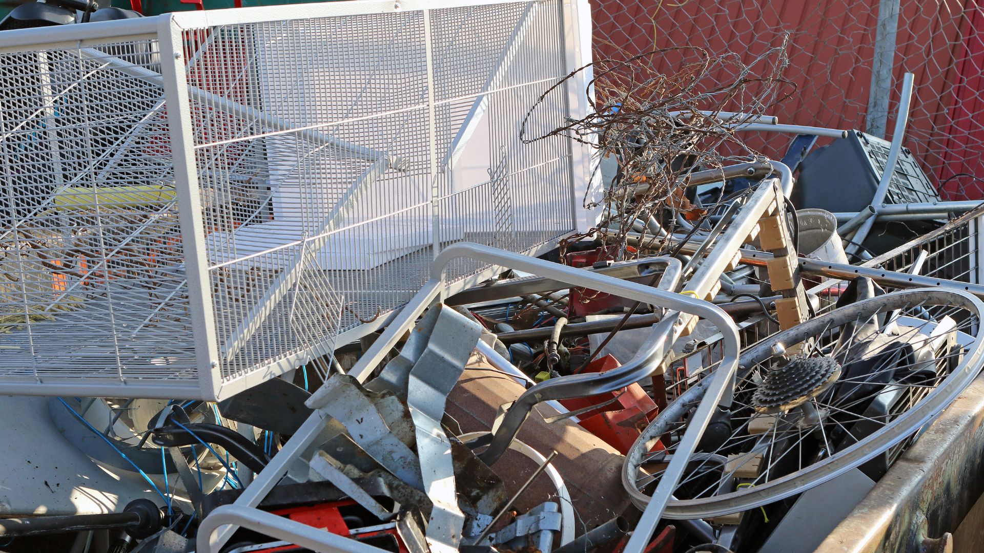 A pile of junk sitting next to a fence